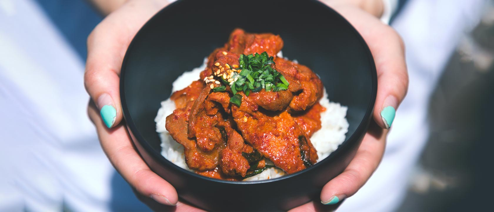 Close up of lady holding home made curry.