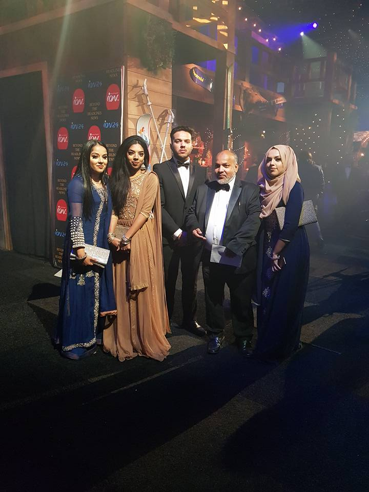 Group of people attending an awards ceremony.