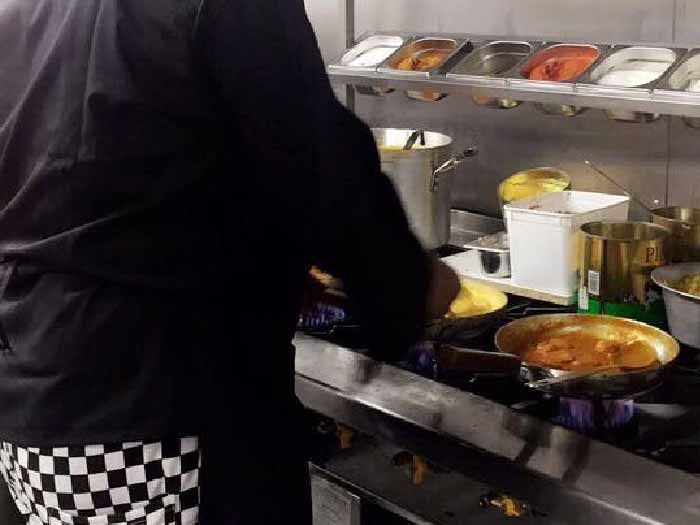 Chef cooking indian food.