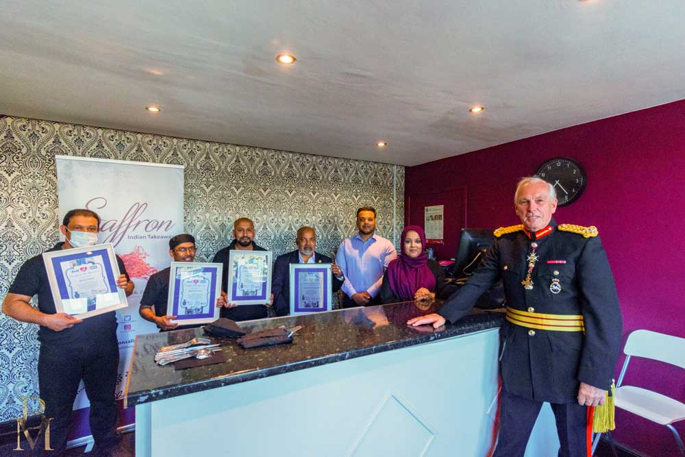 Group of people holding awards.