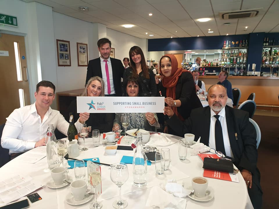 Group of people around a table supporting small businesses.